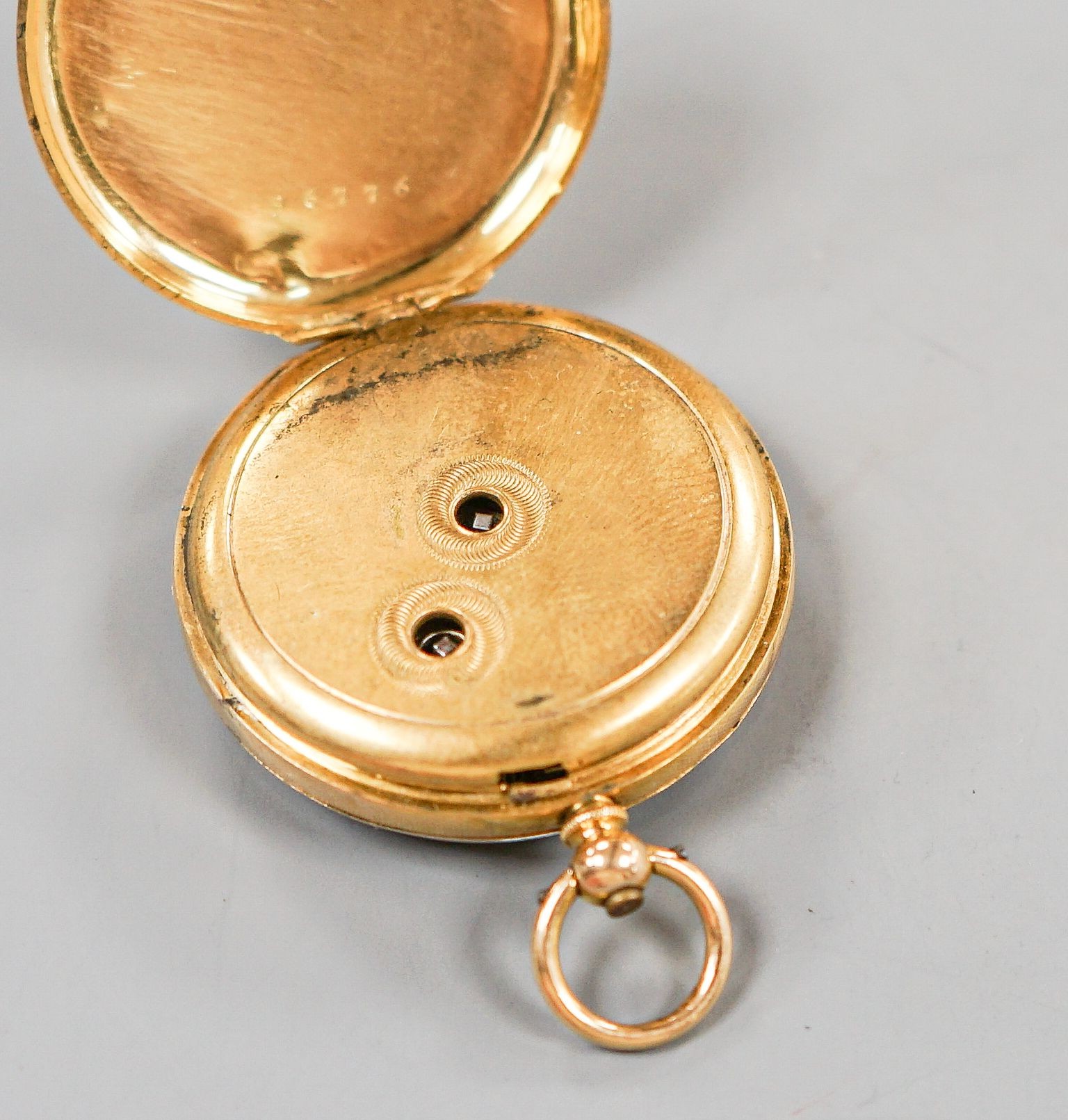 A continental yellow metal, enamel and diamond chip set open face fob watch, decorated en verso with the bust of a lady